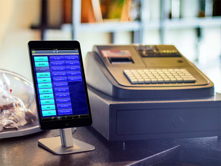 wavesoft software on iPhone sitting next to cash register