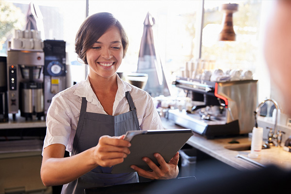 cashier using ipad to swipe credit card